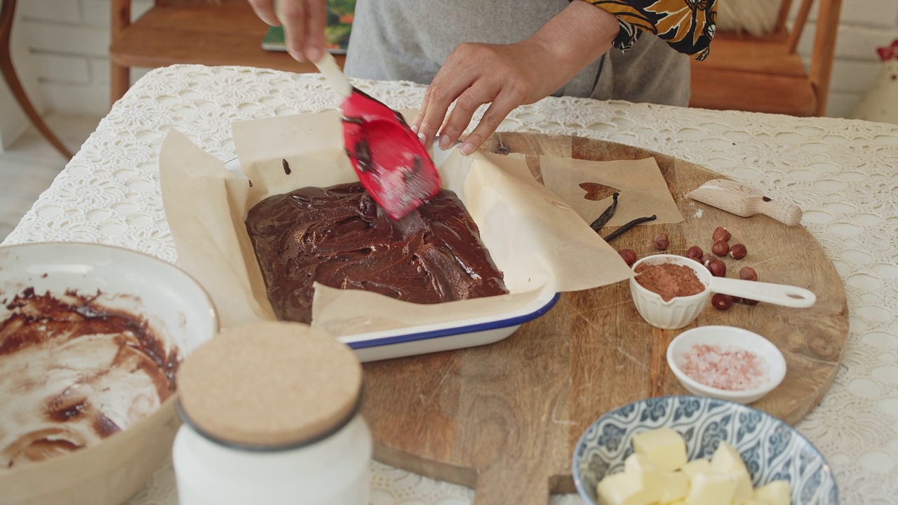 在平底锅上烤巧克力布朗尼面糊的女人视频素材