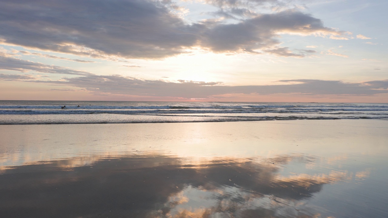 日落时分的哥斯达黎加海滩，有三个人体滑板者视频下载