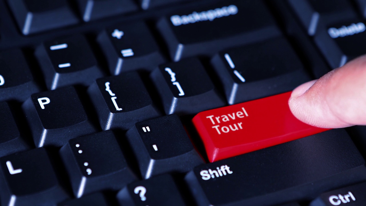 视频片段显示，人的手指按下了电脑键盘上红色的“旅游”按钮视频下载