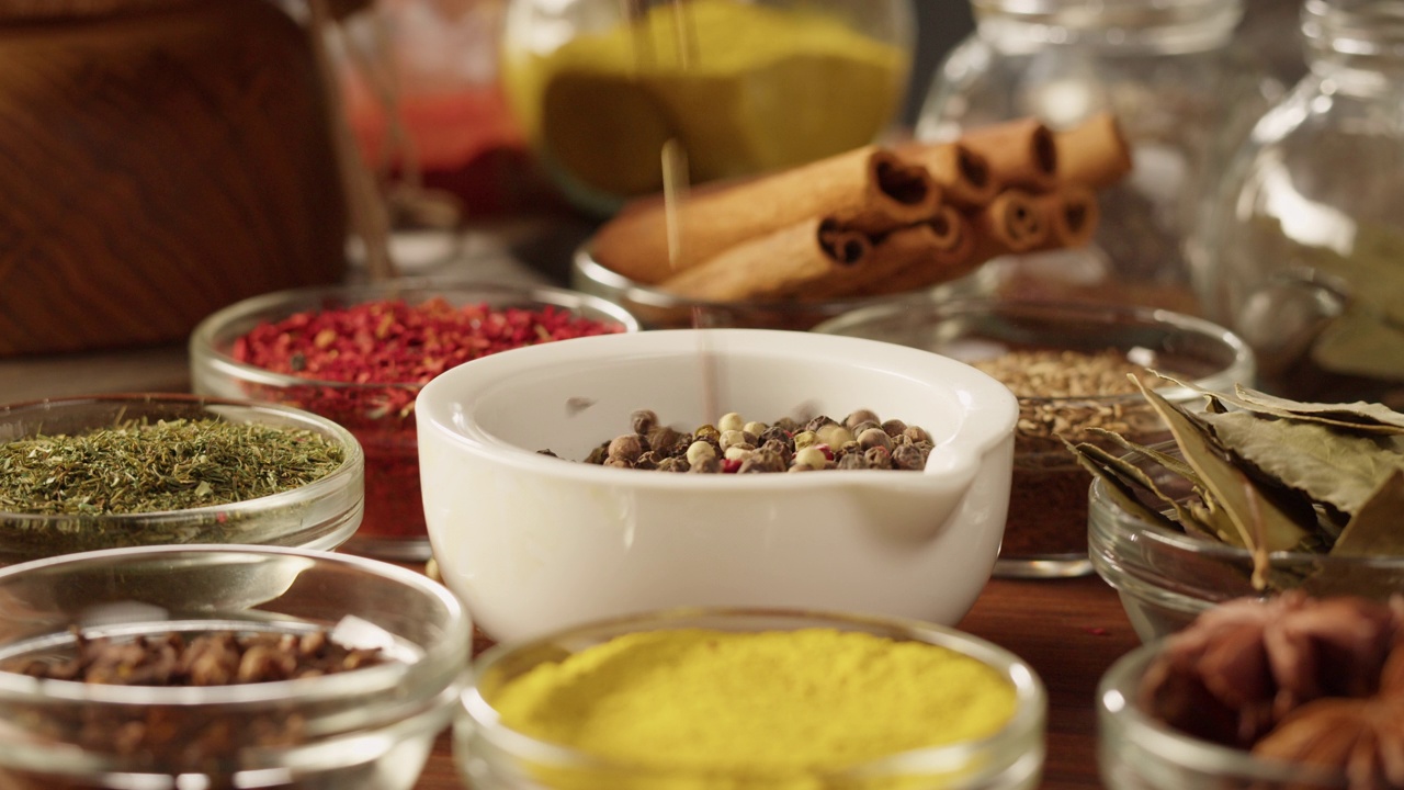 玻璃碗里五颜六色的香料。中东和阿拉伯文化。调味料和口味。胡椒，香菜，肉桂，姜黄，辣椒粉，孜然。烹饪用的不同种类的干香草。视频下载