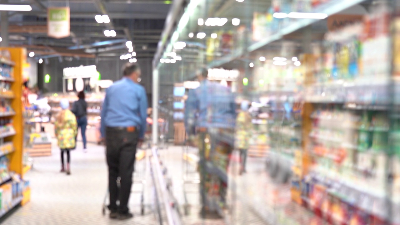 一位男性购物者进入超市寻找食品视频素材