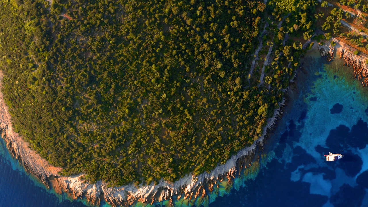 无人机在阳光明媚的日子飞过蔚蓝的海湾。视频素材