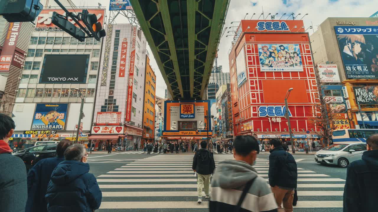 日本东京秋叶原市，人群在汽车交通的天桥上行走视频下载