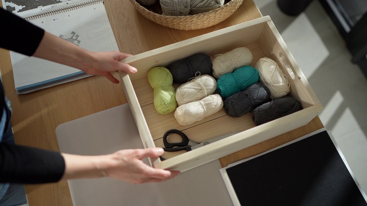 在家里，女人手拿着编织用的配件视频素材