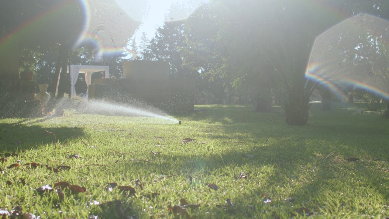 草坪浇水系统，阳光天气炎热，增加植物水分平衡视频素材