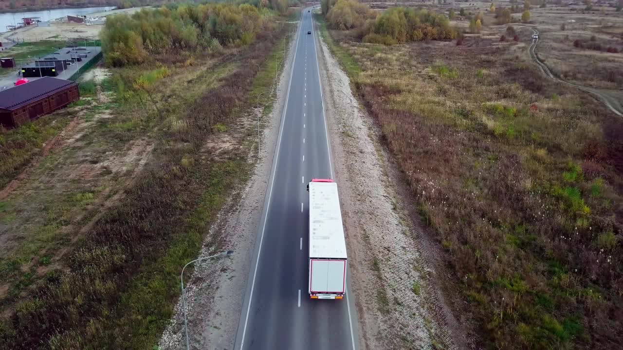 汽车在州际公路上的空中后视镜与拖车卡车超车。视频下载