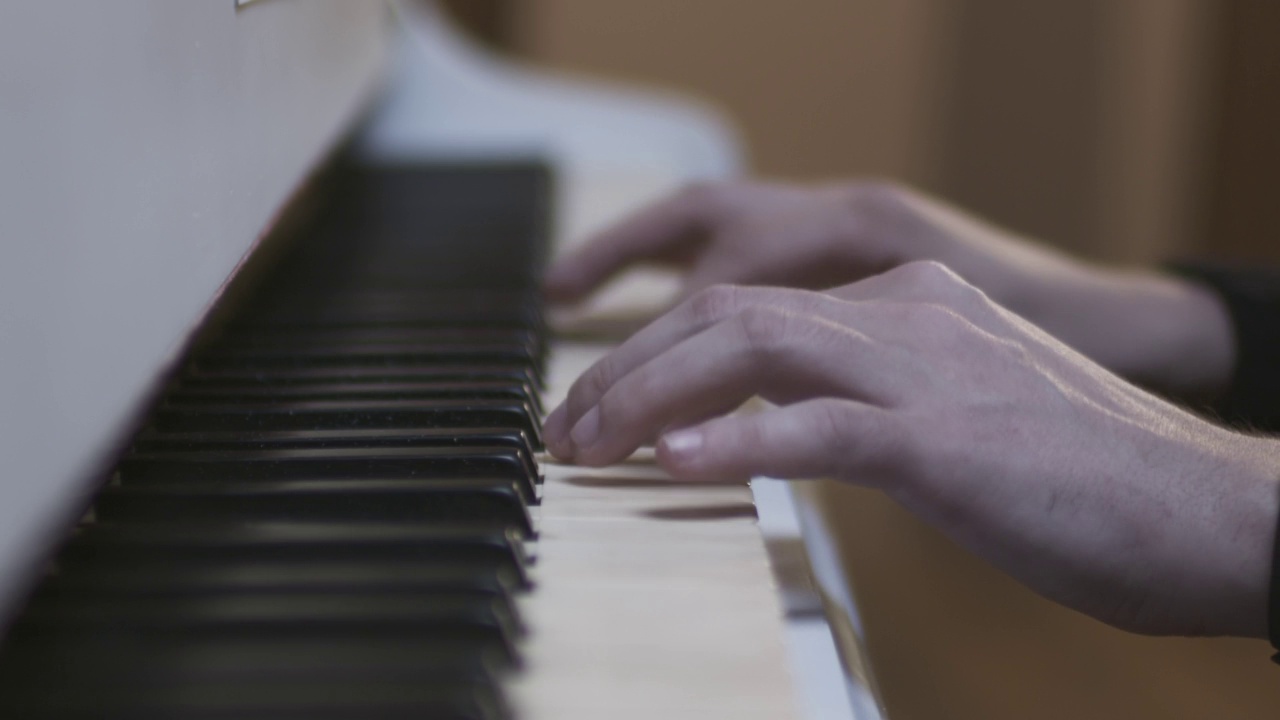 双手在白色钢琴上弹奏视频素材