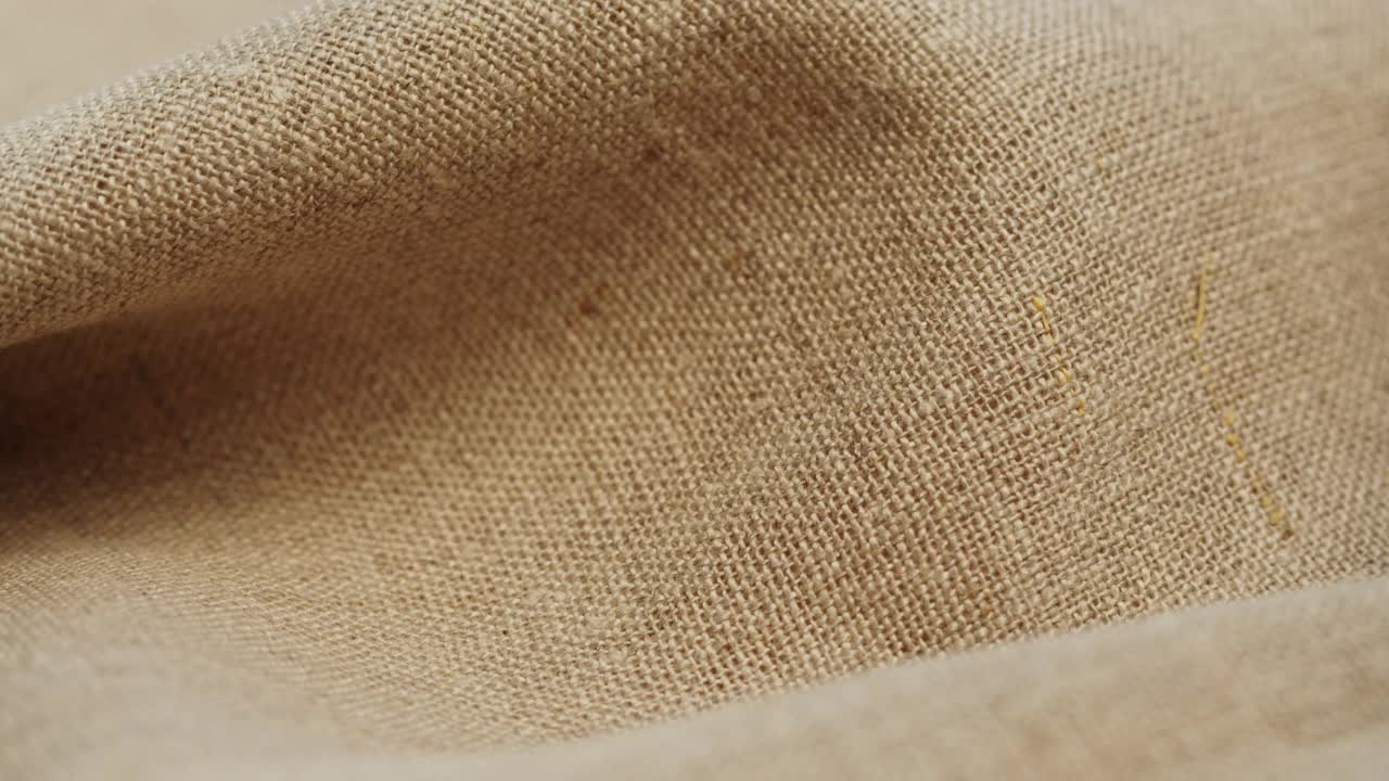 米色织物特写，浅棕色布料纹理背景。棉织物的微距拍摄视频素材