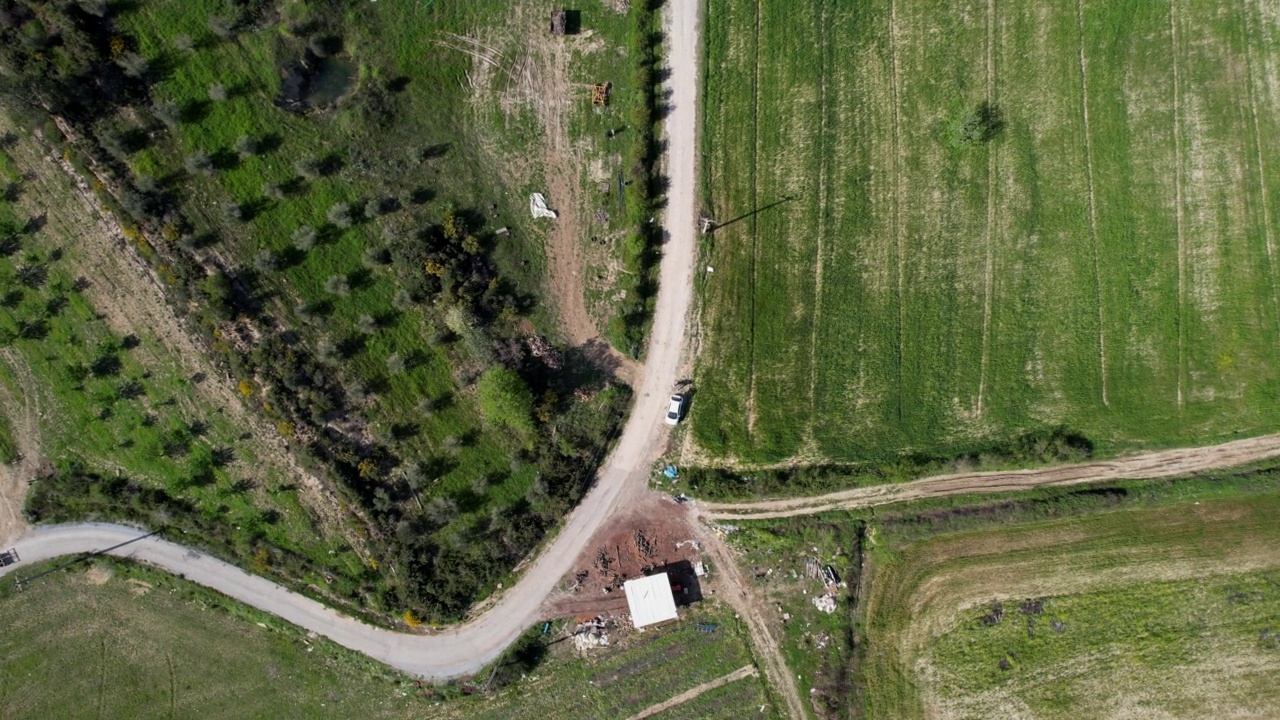 用无人机记录拖拉机在壮丽的田野间经过。视频素材
