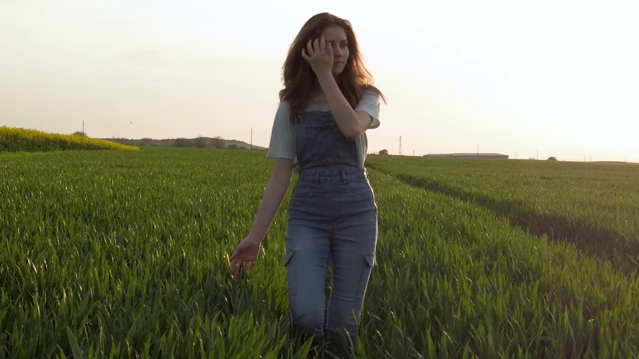 一个年轻的女人正穿过玉米地视频素材