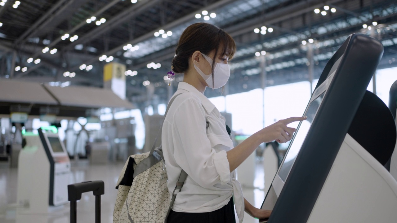 亚洲年轻女子在机场候机楼自助登机视频素材