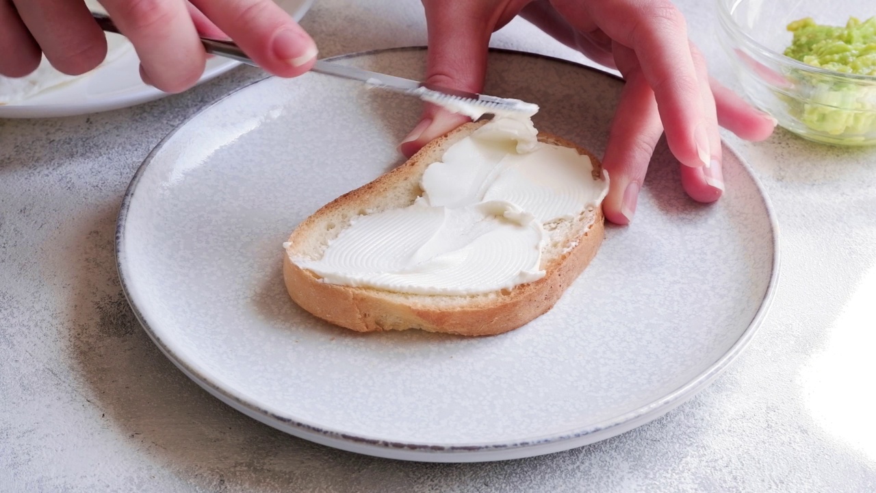 在面包上抹奶油芝士的特写视频下载