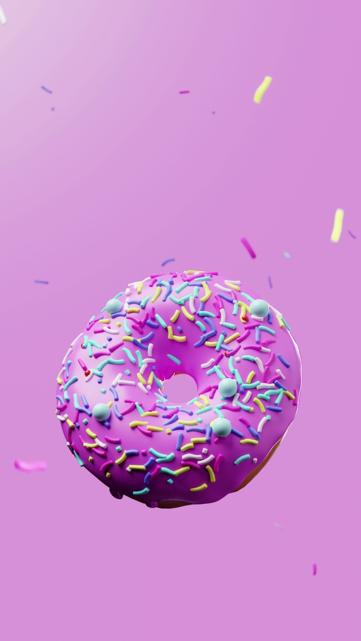 美丽的新鲜甜甜圈旋转特写上方的粉红色明亮的背景与悬浮喷洒，垂直镜头，拷贝空间视频下载