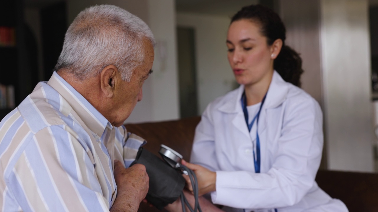 友好的女医生在出诊时为老年男性病人检查血压视频下载