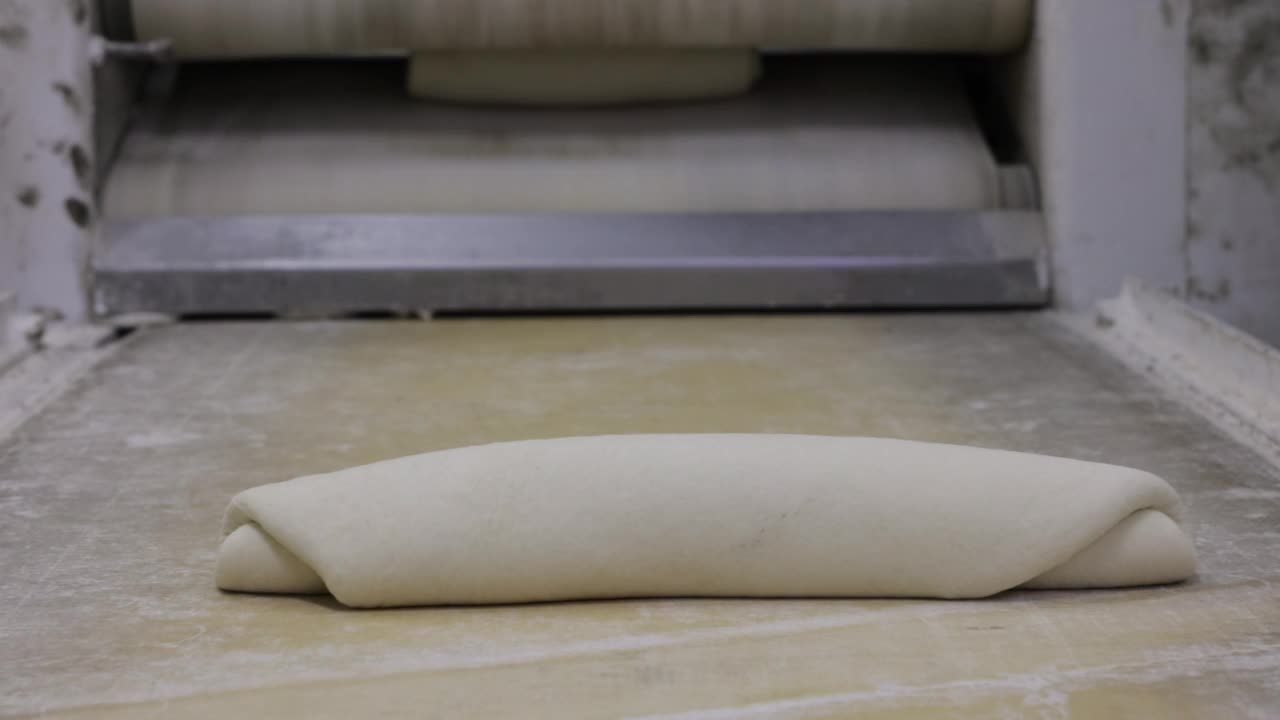 当面包师准备面团时，面包店的机器喷出面团视频下载