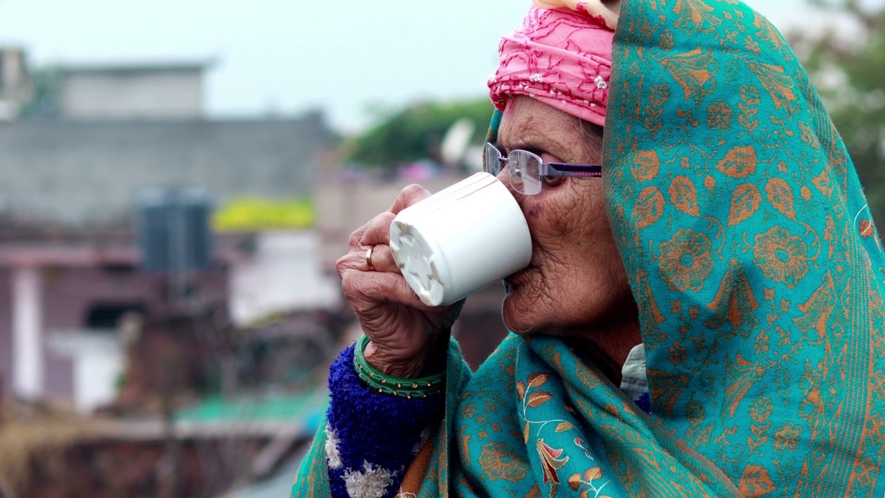 印度农村的老妇人在清晨喝茶视频素材
