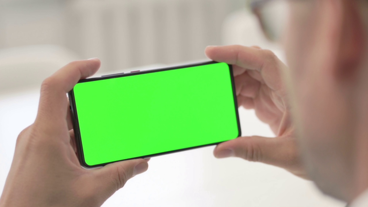 男子使用绿色屏幕的智能手机视频素材
