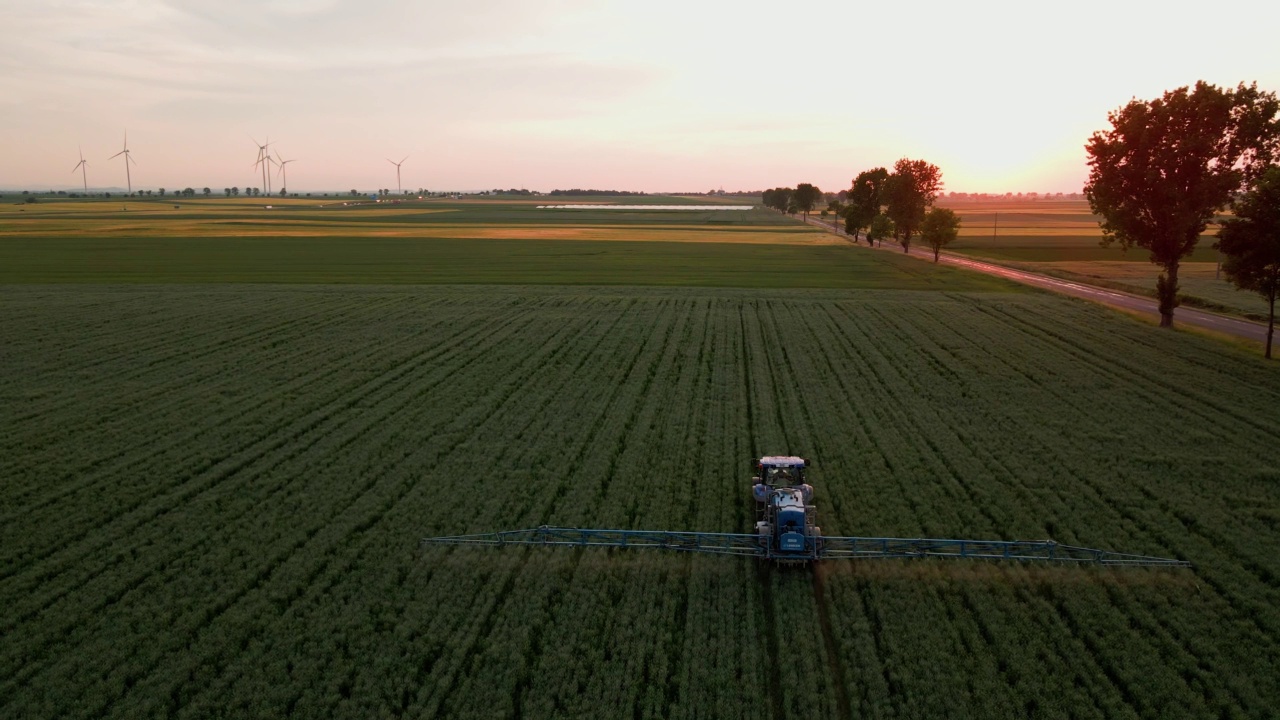 拖拉机在农田上喷洒肥料，鸟瞰图视频素材