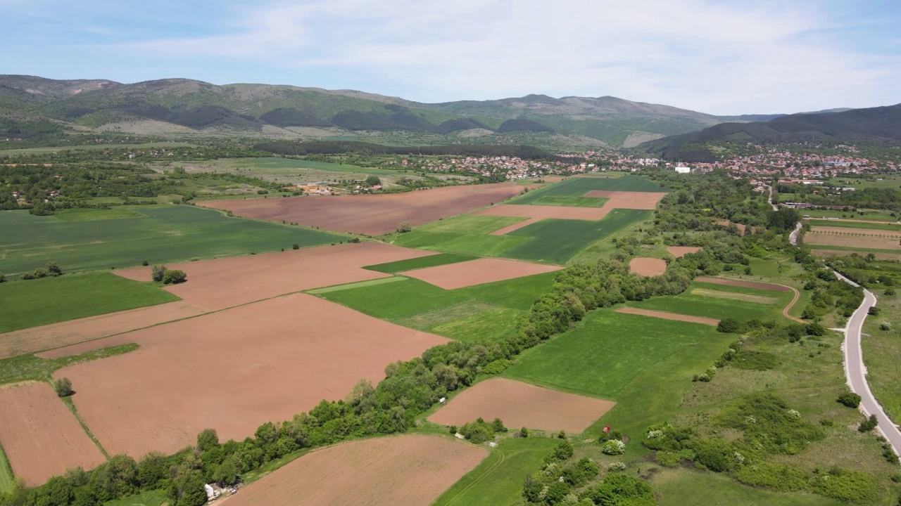 春天鸟瞰保加利亚城镇附近的农村土地视频素材