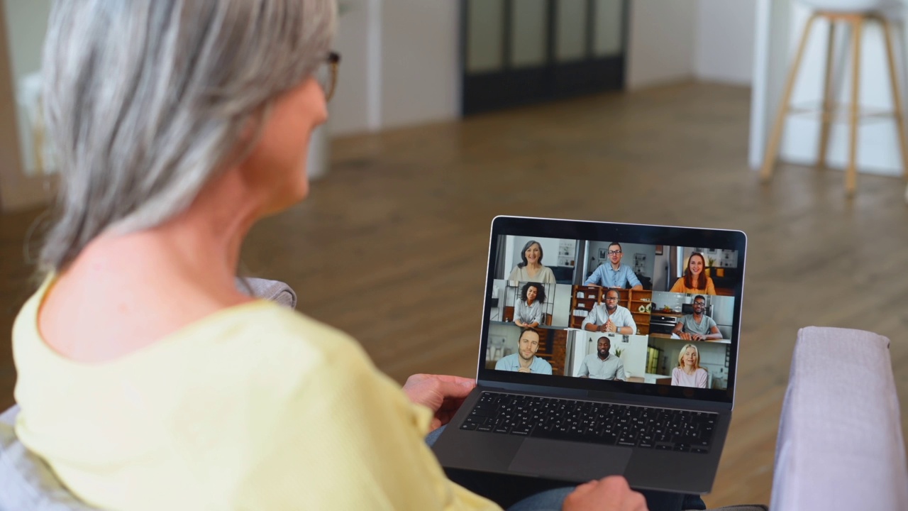 现代退休妇女欢迎在线会议的参与者视频素材