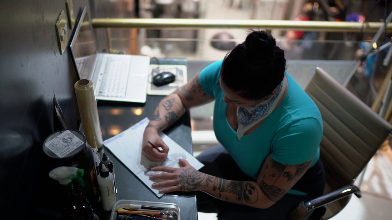 纹身师在纹身工作室画纹身模板的肖像视频下载
