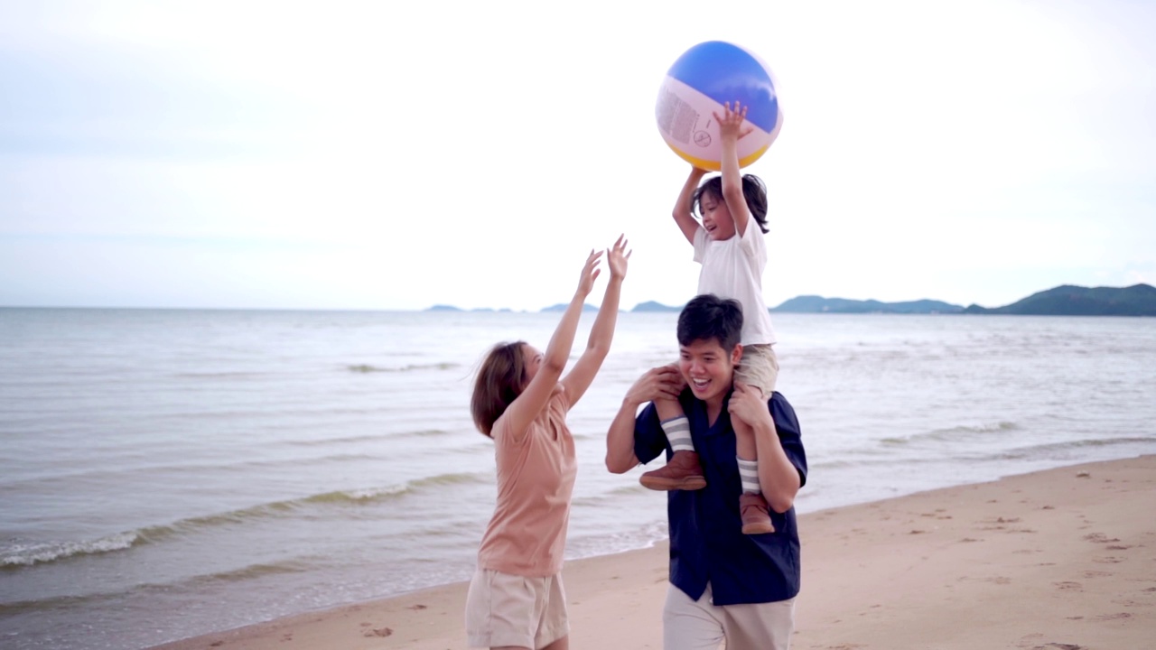 快乐的亚洲家庭带着孩子们在热带海滩旅行和放松。团聚和户外活动的生活方式。视频下载