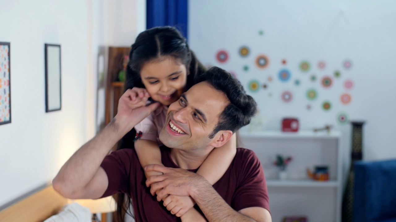 一个可爱的女儿和她的父亲玩猜谜游戏-幸福的印度父女二人组，在一个幸福的家庭中度过童年视频素材