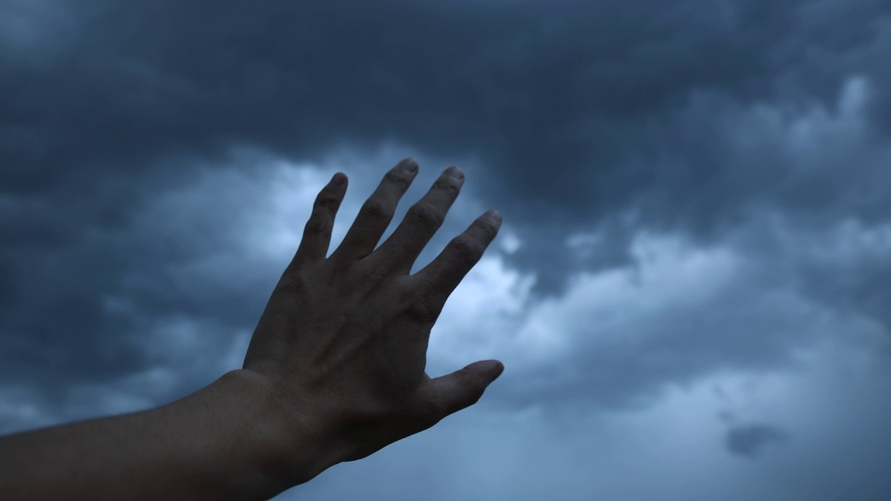 一只手指着乌云密布的天空视频素材