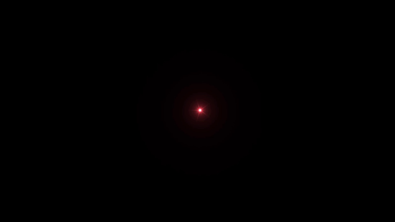现实的红光透镜耀斑隔离在黑色背景。视频素材