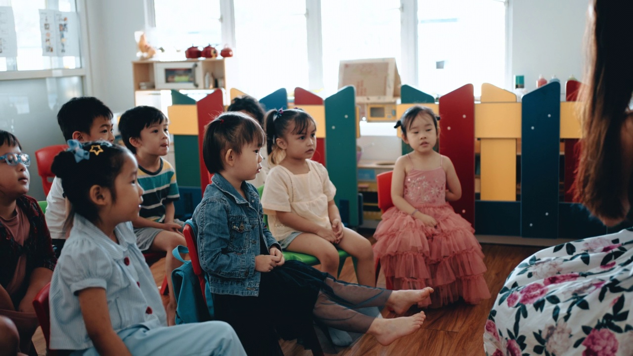 亚洲蒙特梭利幼儿喜欢在课堂上听老师讲故事视频素材