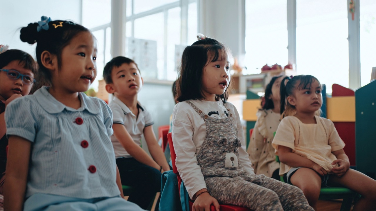 亚洲蒙特梭利幼儿喜欢在课堂上听老师讲故事视频素材