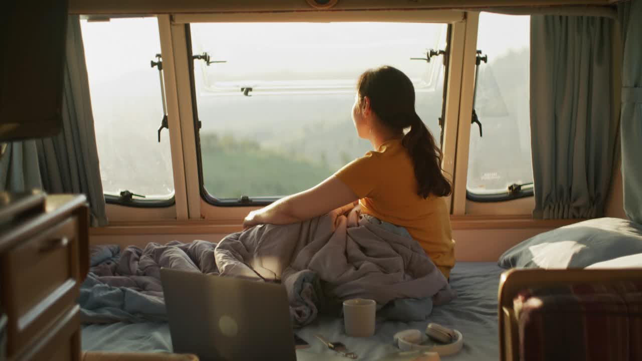 在露营车里看风景喝茶的女人视频素材