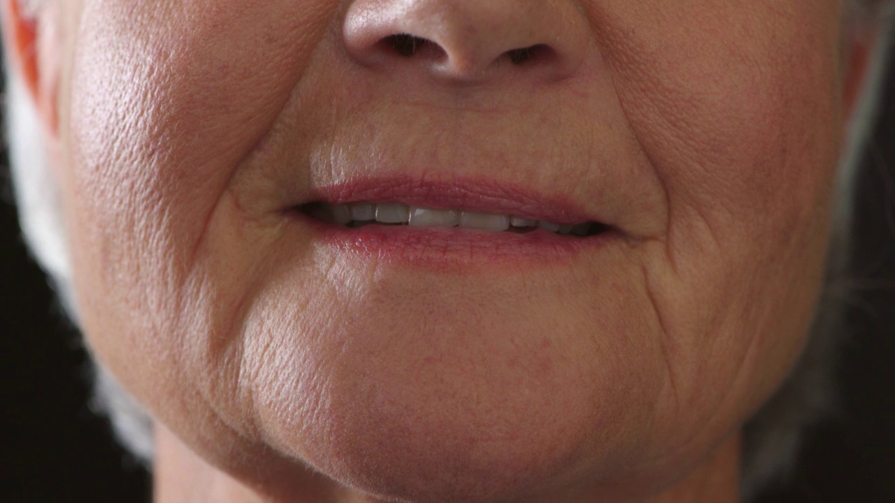 一名因不健康的生活习惯导致牙齿问题、牙齿发黄的老年女性。特写的一个老女性与坏的口腔卫生需要一个牙医检查。一个带着腐朽微笑的成熟的人视频下载