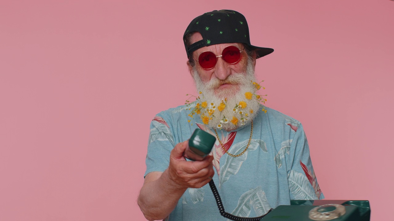 疯狂时髦的老年老人在80年代的老式有线电话上讲话，开玩笑，做鬼脸视频素材