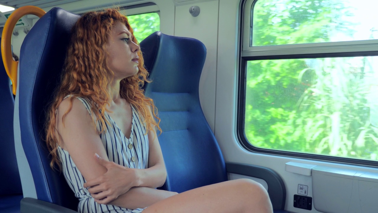 假期，夏天，年轻女人坐在火车里无聊地看着窗外视频素材