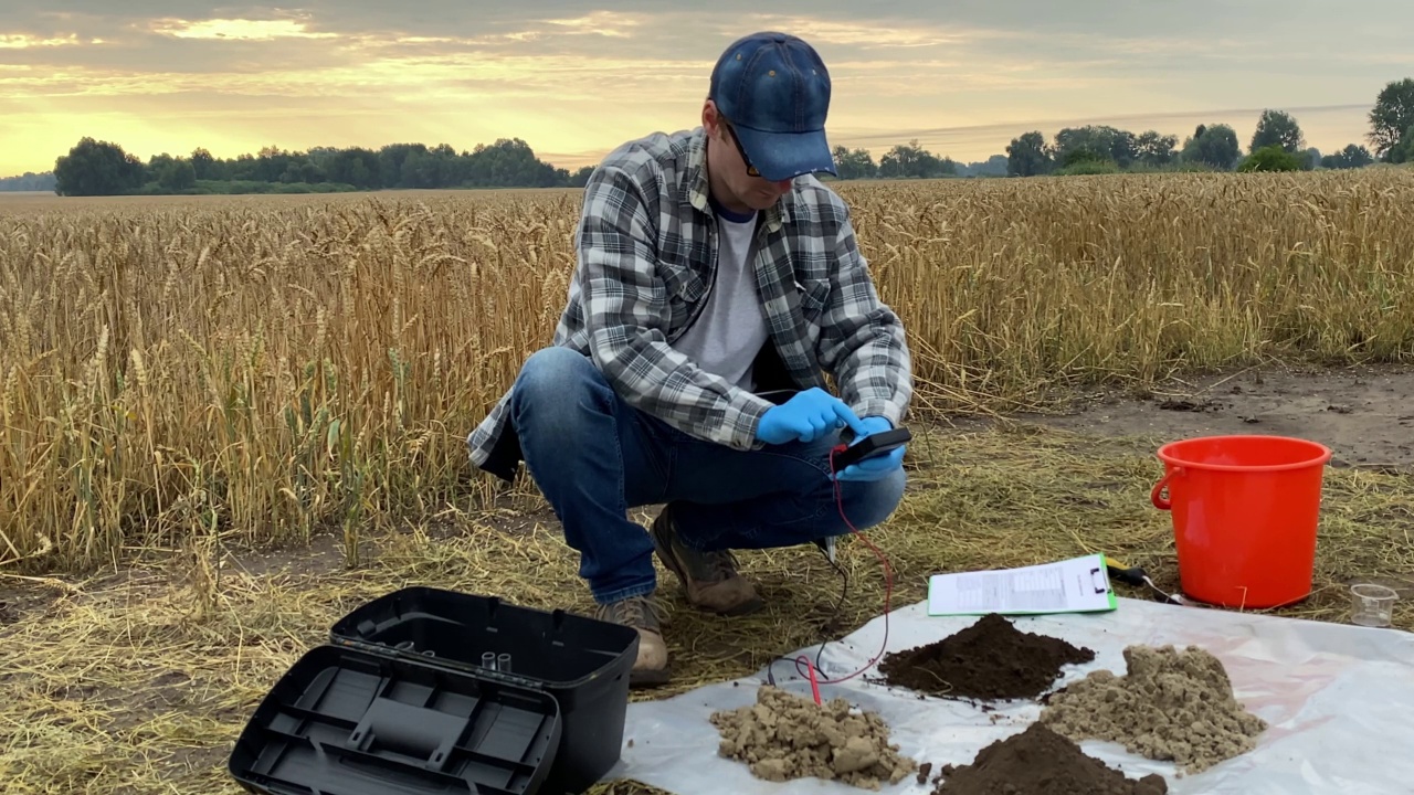 农学家在野外准备土壤测量数字装置视频素材