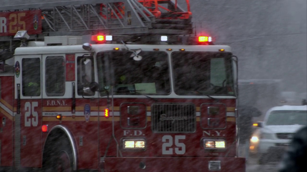 纽约消防车在大雪中疾驰过十字路口视频素材