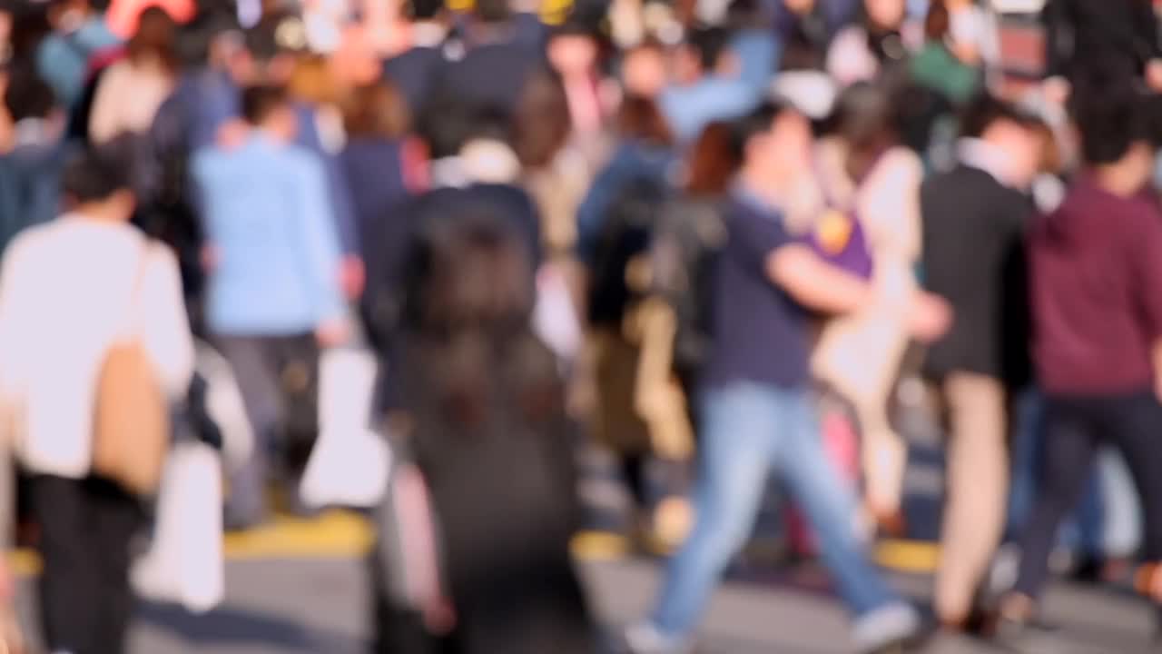 模糊的日本人穿过东京的街道。商业区。高峰时间人们走在人行道上。日本视频素材