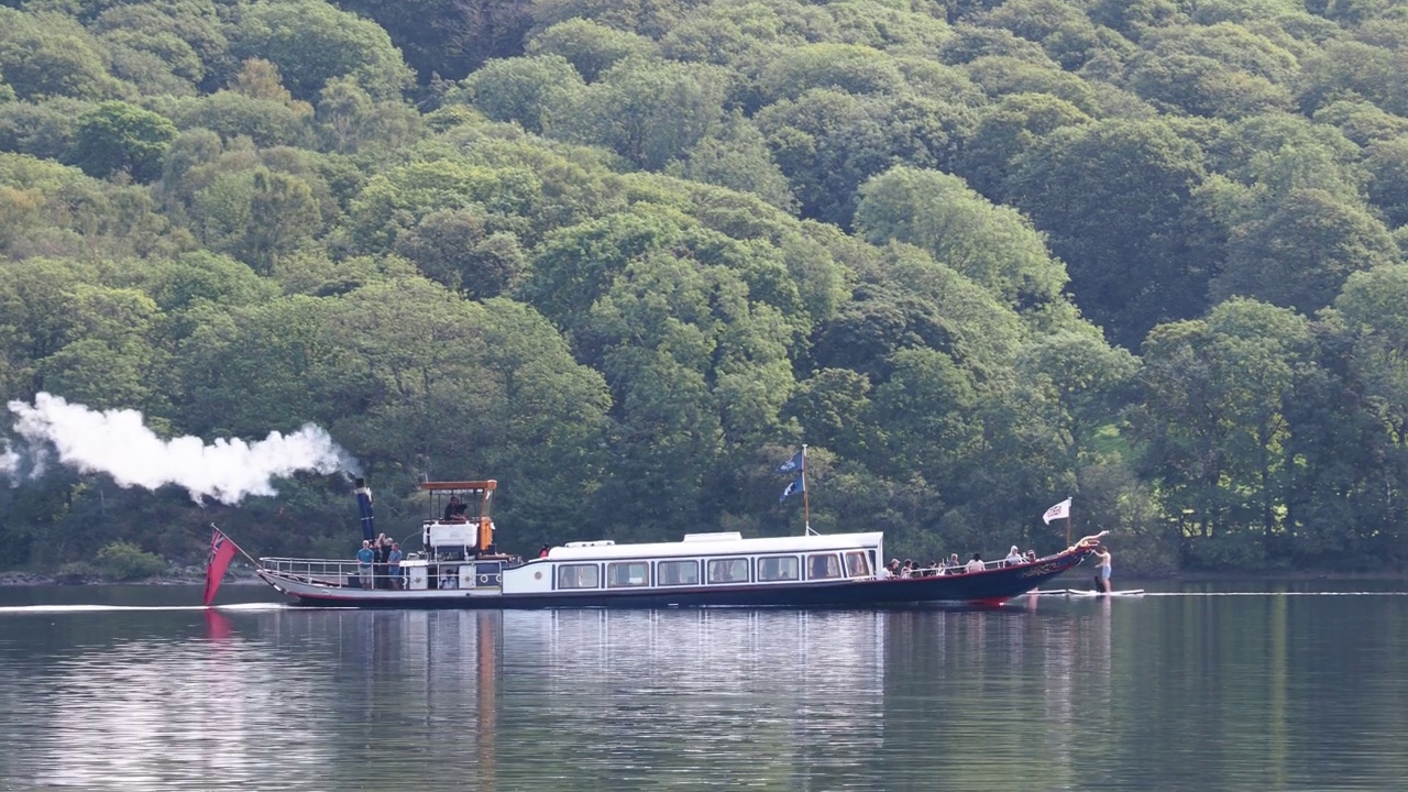英国湖区康尼斯顿水上的蒸汽贡多拉船和划船者。视频下载