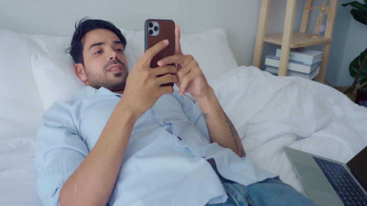男人用手机旅行卧室视频素材