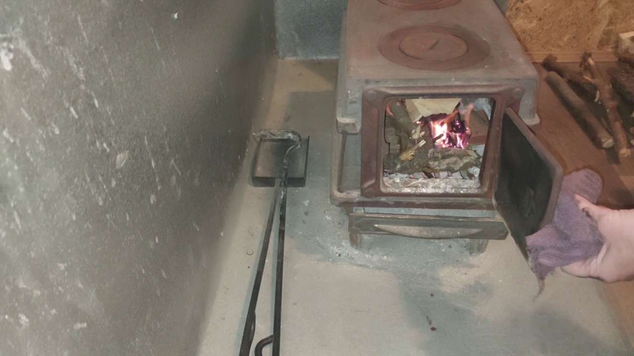 铸铁炉里烧着的柴火使房子暖和起来视频素材