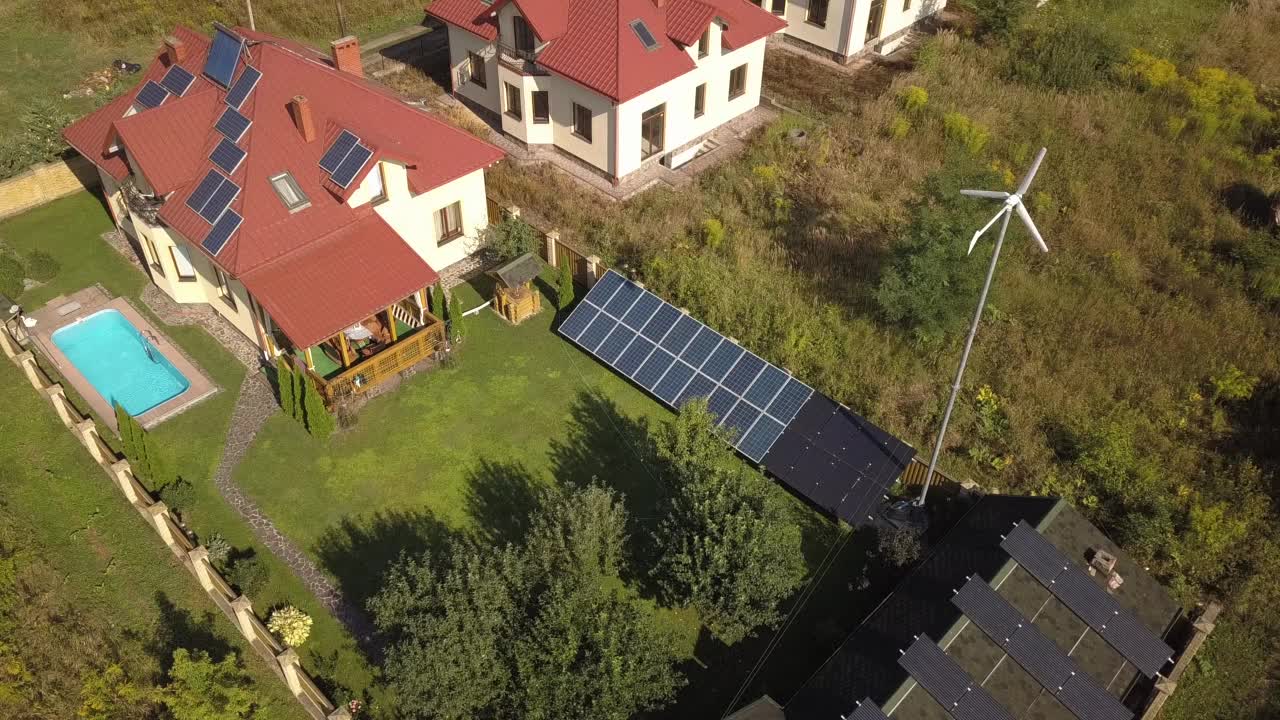 私人住宅的鸟瞰图，屋顶有太阳能板和风力发电机涡轮机视频素材