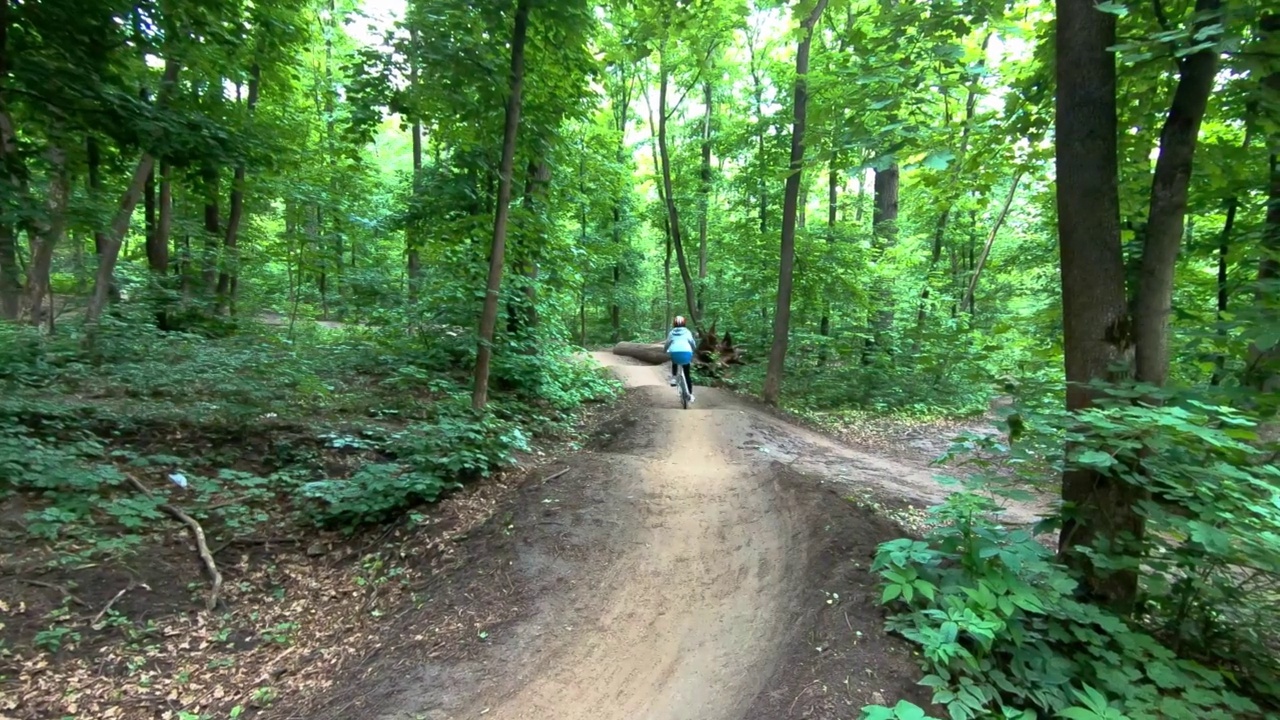 十几岁的女孩在森林里骑自行车视频素材