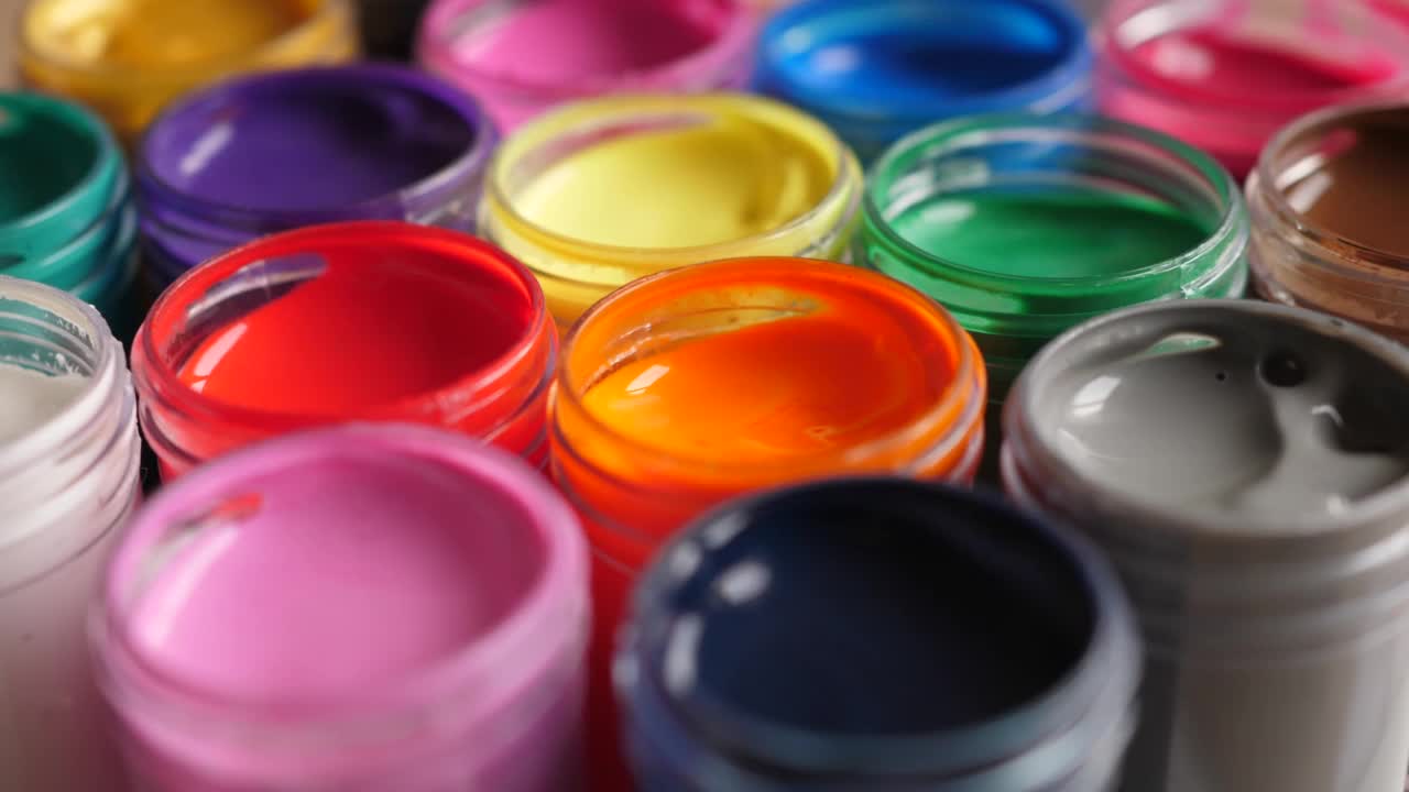 设置水粉颜料在罐中明亮的颜色接近。彩色水粉在塑料瓶上的旋转组。旋转多色背景。背景多色油漆。创意绘画艺术爱好。视频素材