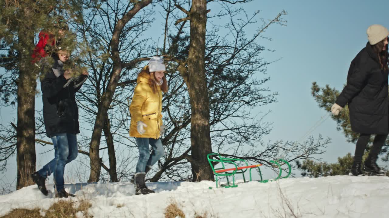 冬天，一家人在雪地里欢声笑语。城市公园冬天的一天。视频素材