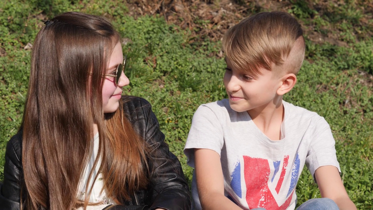 在波兰弗罗茨瓦夫，十几岁的男孩和女孩坐在一起欣赏河水视频下载