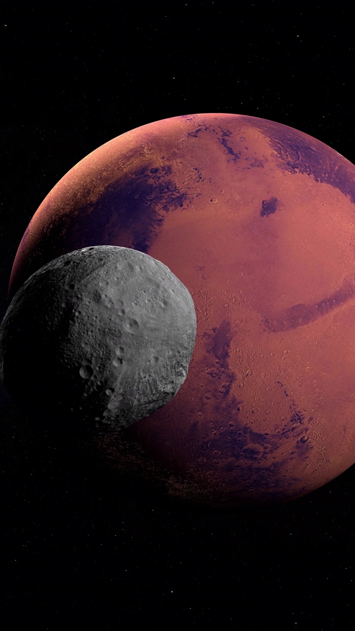 小行星灶神星在外层空间绕轨道运行，当它穿过火星时。4K垂直视频素材