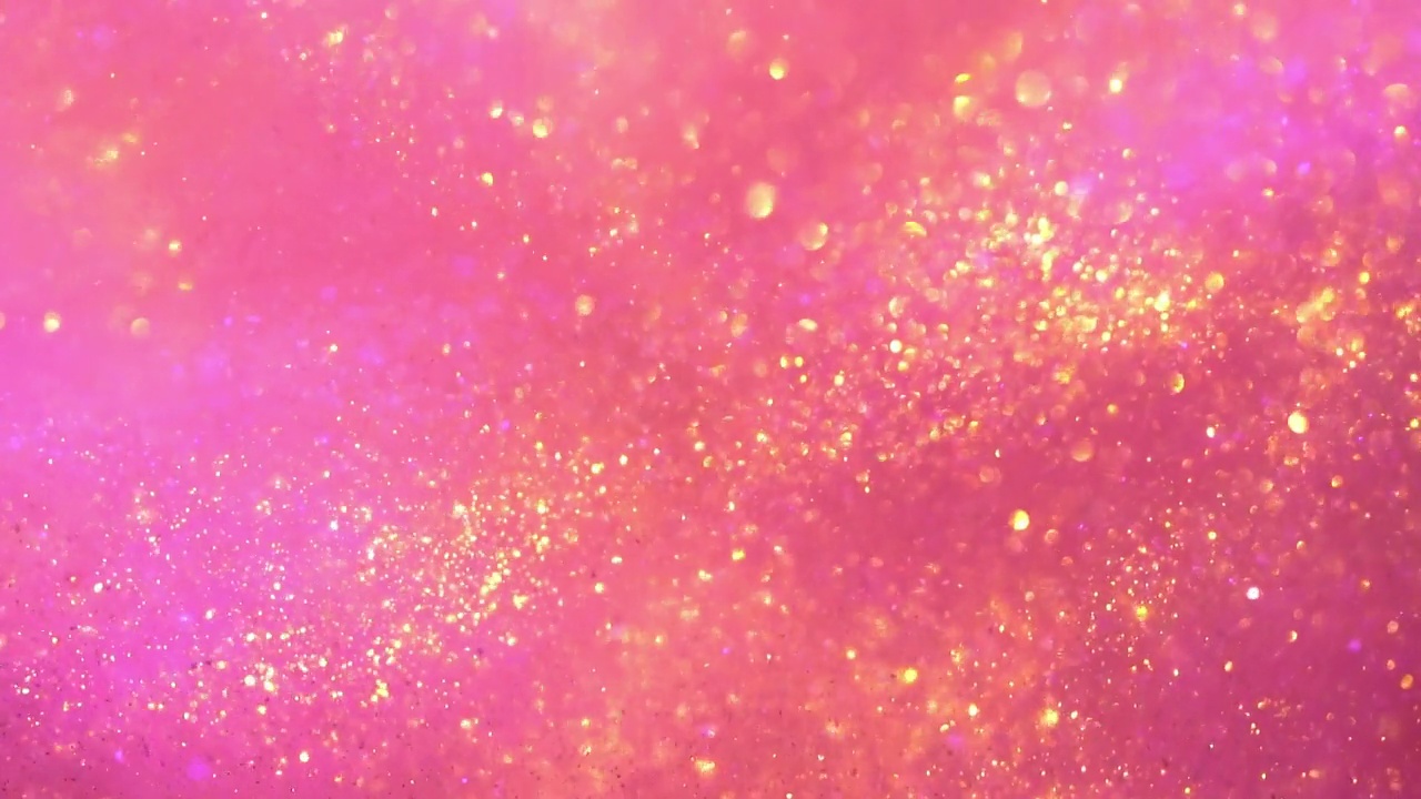 在粉红色背景上飞行的金色粒子的波浪运动。视频下载