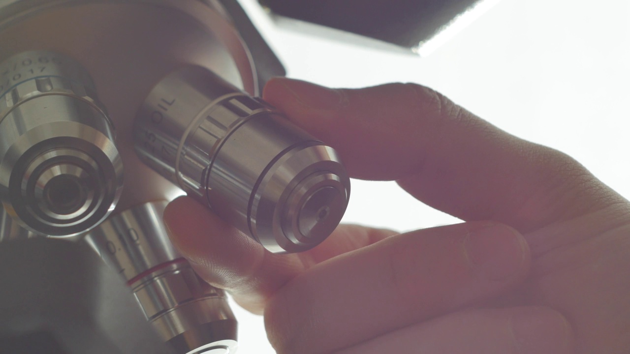 科学家转动显微镜镜头。视频下载