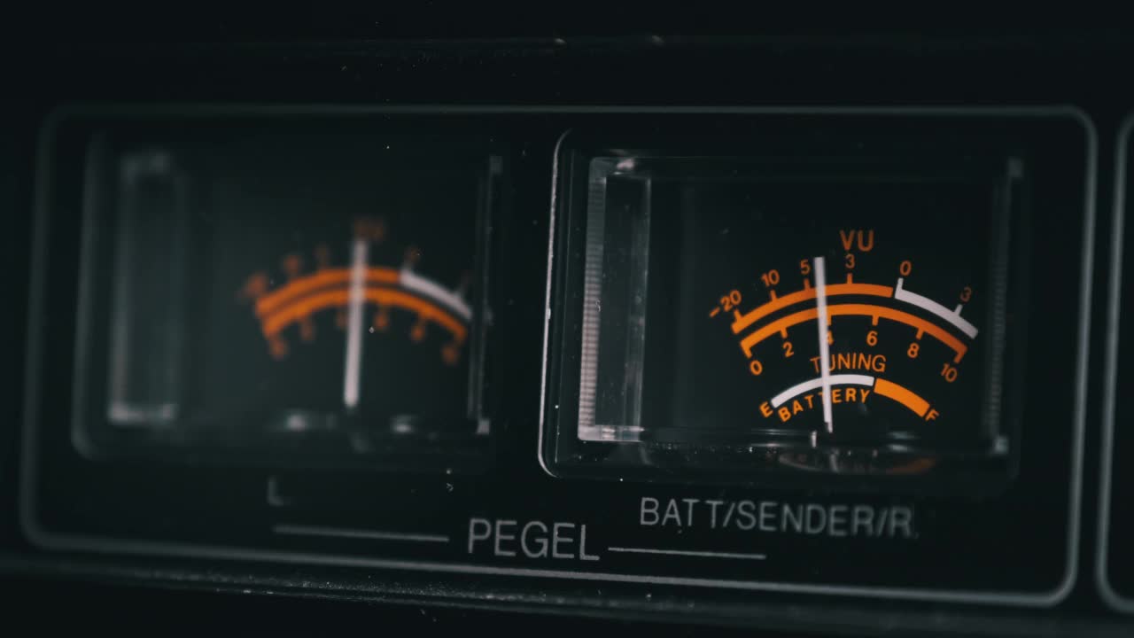 黑色立体声录音机上的模拟VU仪表，箭头指示视频素材